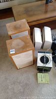 Pair of large wooden JVC Electra speakers with visible water damage on top and a pair of smaller white satellite speakers, along with a Hitachi stereo tuner showing the overall lot contents.