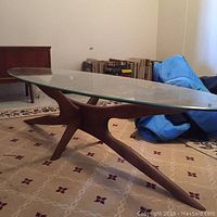 Overall view of coffee table showing teak base and oval glass top
