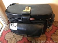 Main black leather carrying case closed, front view