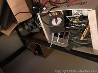 Photo showing the darkroom timer with dial and assorted lights and accessories in a box.
