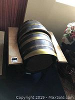Two Electro-Voice barrel speakers resting on stands, showing the full barrel shape with brass bands and black finish.