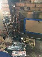 Photo of iron fireplace tools and fire logs near fireplace