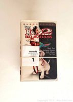 Single VHS tape of 101 Dalmatians wrapped with a rubber band, showing front cover with Glenn Close and two dogs.