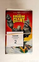 Front cover of The Iron Giant VHS tape showing artwork of the giant robot and a boy
