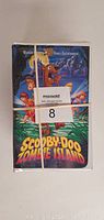 Front view of one Scooby-Doo VHS tape titled 'Scooby-Doo on Zombie Island' wrapped in rubber bands