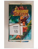 Front view of the stack of VHS tapes tied with string, showing the cover of Tarzan