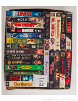 Photo showing 24 assorted VHS movies with visible titles.