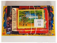 Top view of bundled games including Lord of the Rings Risk and Robin Hood card game with rubber bands securing.