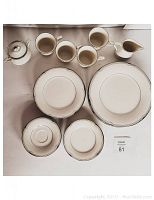 Top-down photo showing 4 cups, 4 saucers, 4 dinner plates, 4 salad plates, 4 bread and butter plates, 1 creamer, and 1 lidded sugar bowl arranged neatly on a table.