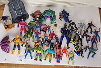 Overview of entire lot showing 28 Marvel action figures and accessories on white background