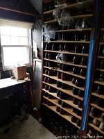 Wooden shelving unit filled with men's shoes size 11
