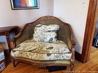 Front view of Regency House loveseat with carved wooden frame and detailed patterned fabric upholstery, includes a matching cushion.