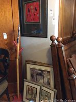 Wall art displayed stacked and hung, showing variety of frame sizes and art themes including a gold framed bathroom set and abstract prints.