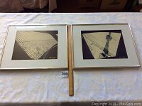 Two framed black and white photos side by side with a ruler showing size