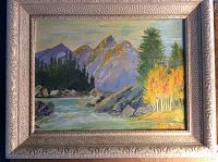 Front view of framed oil on board painting depicting mountain river landscape with trees and rocks