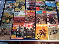 Photo shows a flat layout of about 15 vintage magazines mostly from the 1970s. Includes various titles focused on motorcycles, cars, and model railroading.