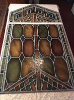Upper and lower stained glass panels displayed flat on table