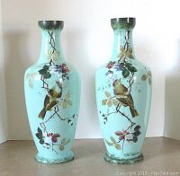 Front view of pair of celadon green vases with detailed hand painted birds and florals.