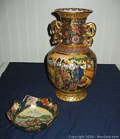 Full view of the Asian Satsuma vase and small bowl displayed on blue cloth background