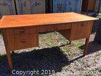 Full front view of desk outdoors on gravel