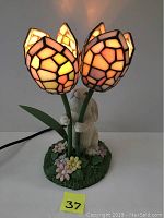 Front and top view showing three stained glass tulip leaves illuminated, ceramic bunny and flower base detail