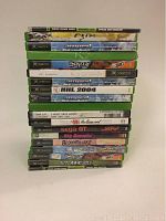 Stack of 19 Xbox game discs in cases with visible titles and wear.