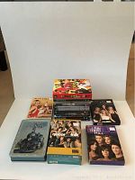 Photo shows 11 DVDs including box sets for The Hills Season 1 & 2, Queer as Folk, The L Word, One Tree Hill, and a special edition metal tin for The Great Journeys.