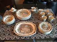 33-piece dinnerware set including plates, cups, creamer, sugar bowl arranged on table.
