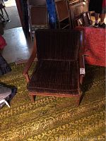 Front view of brown corduroy mid-century modern wooden armchair
