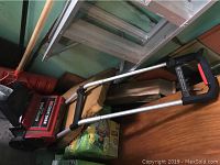 Craftsman electric snowthrower lying horizontally showing handle and front housing