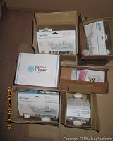 Top view of multiple Martha Stewart Crafts punch sets in original packaging inside 5 boxes.