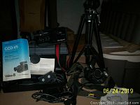 Sony Handycam CCD-V5 Video8 camcorder with accessories including charger, batteries, tapes, and carrying case.