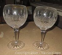 Front view of the two clear crystal goblets with raised diamond pattern on a kitchen counter.
