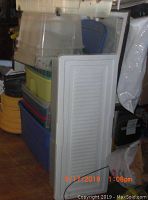 Stack of various plastic storage bins with lids in different colors and sizes.