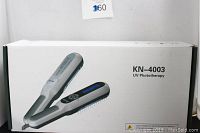 Box of KN-4003 UV Phototherapy device showing product model and device image on packaging.
