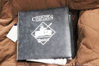 Closed black binder with white 'Collector's Card Album Baseball' logo