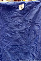Blue vinyl and fleece covering displayed folded and unfolded to show texture and material.