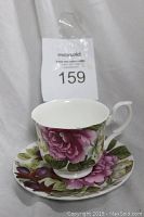 Photo showing the Royal Burlington Staffordshire teacup with pink floral design and curved handle, placed on matching saucer.