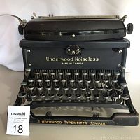 Front view of the black Underwood Noiseless typewriter showing keyboard and front plate labeling.
