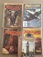 12 vintage Meccano magazines displayed with illustrated colorful covers, some depicting animals, planes, and industrial scenes.