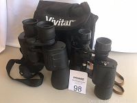 Shows both binoculars together with the Vivitar branded black soft carrying case