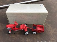 Red Murray Trac pedal car replica diecast tractor with attached dump trailer and original white box behind