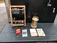 Full lot overview showing clamps on stand, chisel sets, and router bit sets on a black cloth surface.
