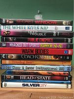 Stack of 13 DVD cases showing titles from various movies and an instructional dance DVD.
