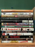 Photo of 13 DVDs stacked to show titles including a mix of movies and specials.