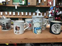 Front view of all six mugs showing their various designs