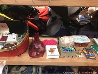 Overall view of basket containing multiple crafting supplies, including buttons, beads, and other accessories