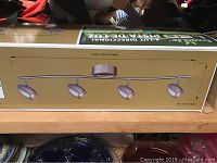 Side view of boxed EnviroLite 4-light directional LED track light fixture showing the product image and dimensions.