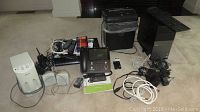 Full lot showing the Dell Optiplex desktop tower, keyboard, Ativa shredder, Caption Call phone, GE VCR, Sony speakers, assorted cables and remotes.
