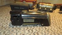 Black Lionel Scout engine tin toy train on carpet.